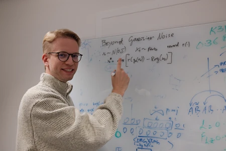 Doctoral Candidate Luca Eyring in front of the board